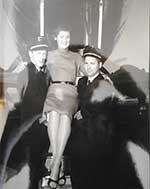 Southwest Airways Pilots carrying woman down back of Martin 404.  L- Earl Spencer? R- R.A. Carrow?