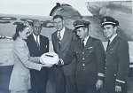 Captain Ernie Clark & his Purser presenting cake to SWA Adminitration Staff to celebrate one year of Scheduled Passenger Service - SFO December, 1947 (Submitted by Ernie Clark's daughter, Sharon Clark DeVos)